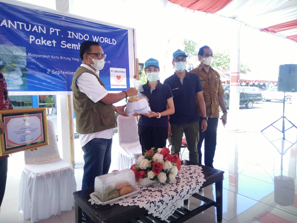 Pimpinan PT Indo World Bitung Piyaporn Udomsri menyerahkan bantuan bahan pokok ke Walikota Maurits Mantiri.